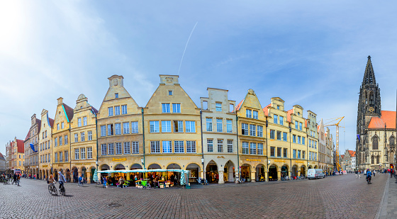 Muenster, Germany - April 29, 2022: scenic view to facade of old historic houses in panoramic view at the Prinzipal markt engl: square of the prince in Muenster.