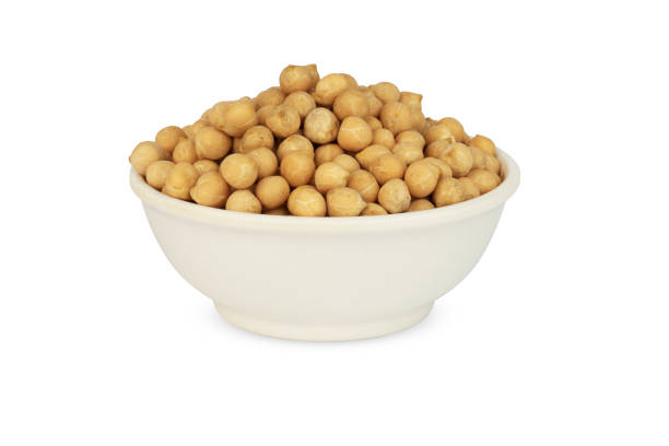 istock chickpeas in a plate isolated on a white background. 1395704429