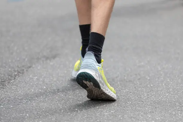 black socks in running shoes on asphalt