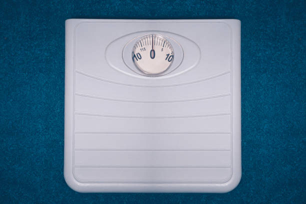istock Mechanical scales on a blue background 1395704619