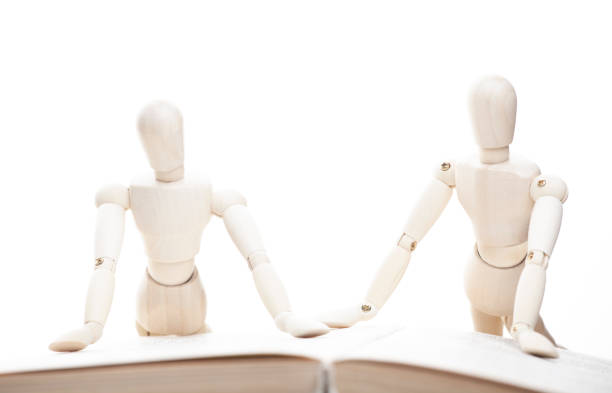istock image of wooden figure book white background 1395707109