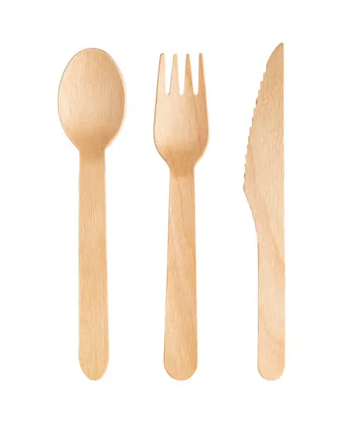 Photo of Disposable wooden cutlery on a white background. Environmentally friendly materials.