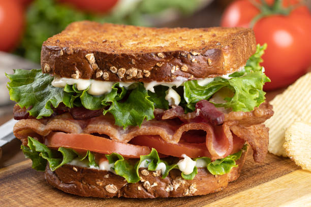 istock Bacon, lettuce and tomato sandwich on a cutting board 1395711266