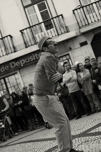 Lisbon, Portugal - December 8, 2012: A street artist performs as a clown at the Rua Augusta street in Lisbon downtown.