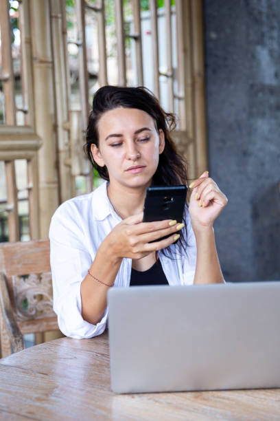 istock Beauitul young diverse woman working remotly using computer laptop concentrated and talking by phone 1395711591