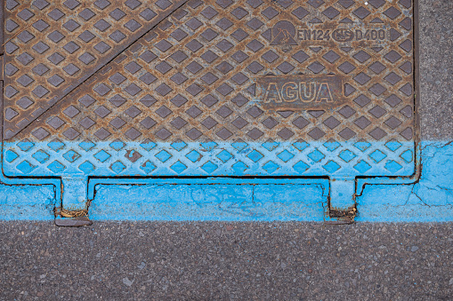 Iron hatch in the street with a blue line in the center of Santa Cruz which is the main city on the Spanish Canary Island Tenerife