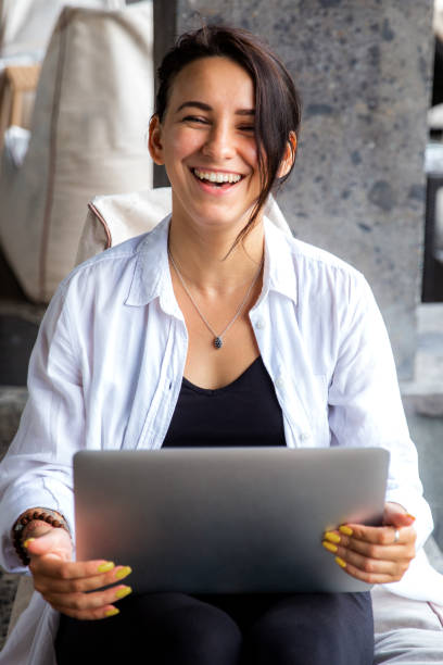 istock Beauitul young diverse woman working remotely using computer laptop concentrated and talking by phone 1395712540