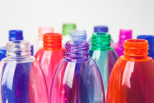 Group of empty coloured plastic bottles and containers for water or detergents. Concept about plastic recycling or chemical pollution