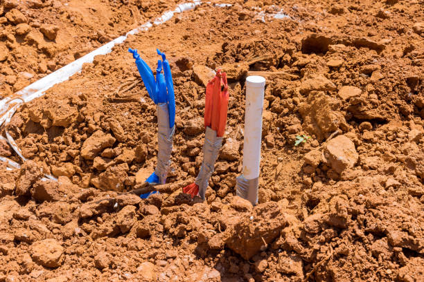 istock Laying water PVC plastic pipes in ground during plumbing construction site. 1395714003