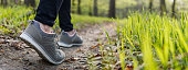 istock Sports shoe walking on footpath in forest 1395714142
