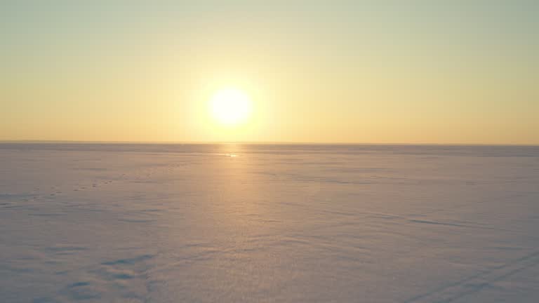 The beautiful sunset view over the endless snow field