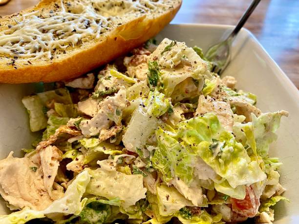 istock Grilled Chicken Caesar Salad with garlic bread. 1395714638