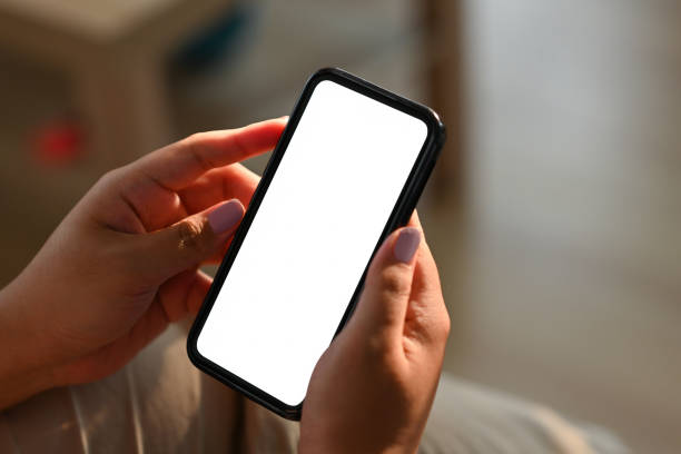 istock Cropped view hands holding a smartphone with a blank white screen, for business and technology concept. 1395714904