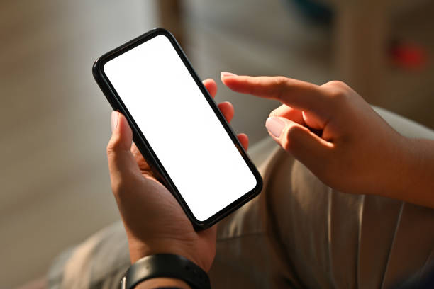 istock Cropped view hand holding a smartphone with a blank white screen, for business and technology concept. 1395714908
