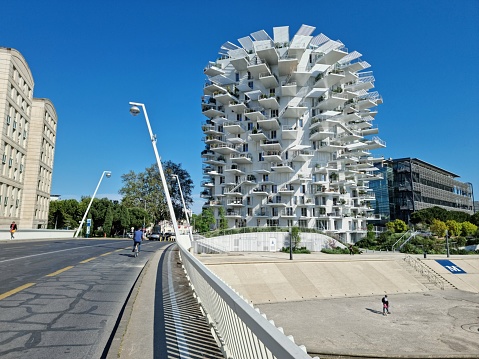L'Arbre Blanc - White Tree is a unique residential bilding in Montpellier. The building was planned by: Sou Fujimoto, Nico­-las Laisné and OXO architects. The construction was finished in 2019 and contain 112 appartements on 17 storeys. the image was captured during spring season.
