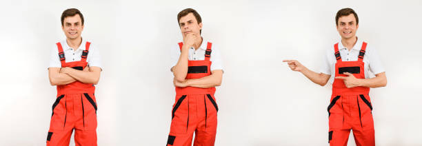 istock Young man contractor repairman builder in red overalls on white background. 1395717755