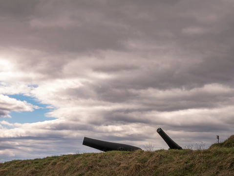 Minimalist view of two cannon barrels on an outer battery at Fort McHenry National Monument, site of British bombardment and successful American defense of the port of Baltimore during the War of 1812