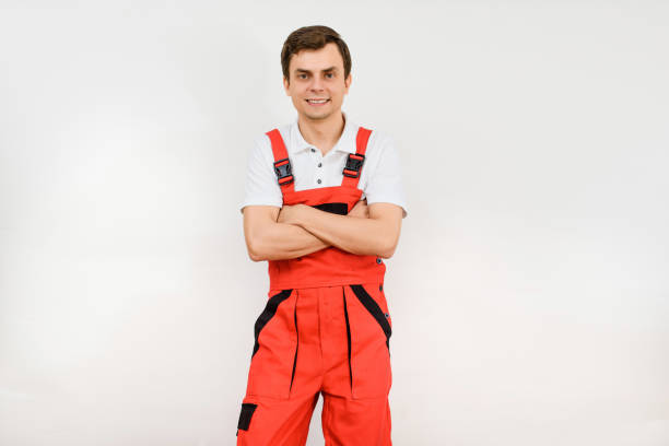 istock Young man contractor repairman builder in red overalls on white background. 1395717928