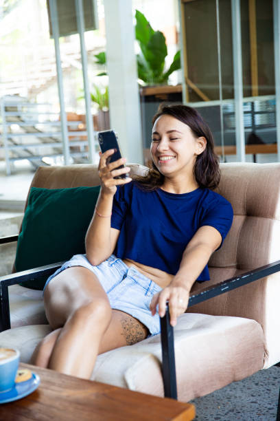 istock Young woman freelancer working with cellphone she sits at the table. 1395718152