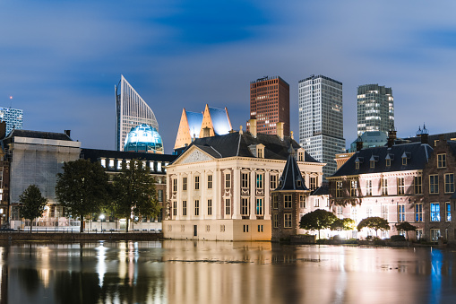 Binnenhof (Government building) with the skyline of The Hague and a beautiful lake reflection during night.