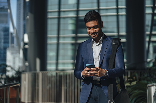 Successful business - Indian man in suit text messaging