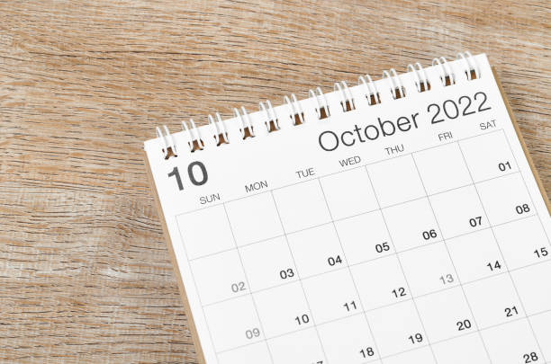 istock October 2022 desk calendar on wooden background. 1395725009