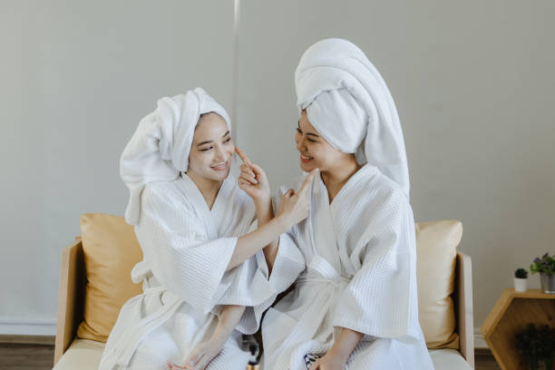 istock women tapping their cheeks happily unwind in the spa center. 1395727550