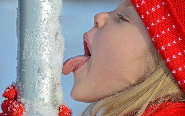 Girl licking flag pole stock photo