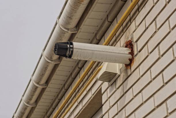 istock one white metal chimney pipe in a gray brick wall 1395728800