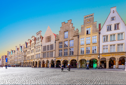Muenster, Germany - April 29, 2022: scenic view to facade of old historic houses in panoramic view at the Prinzipal markt engl: square of the prince in Muenster.