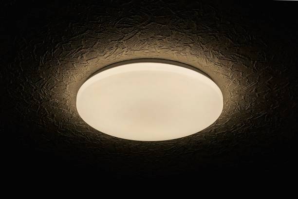 istock one chandelier from a round white shade with lighting on a gray black ceiling 1395729091