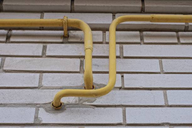 istock metal gas pipes on a white brick wall 1395729195
