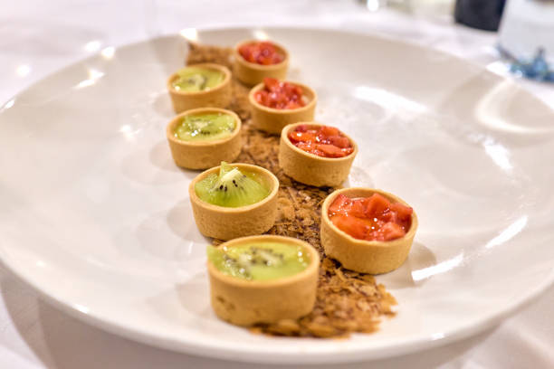 White round plate with fruit tartlets or small pies, no people shown still life