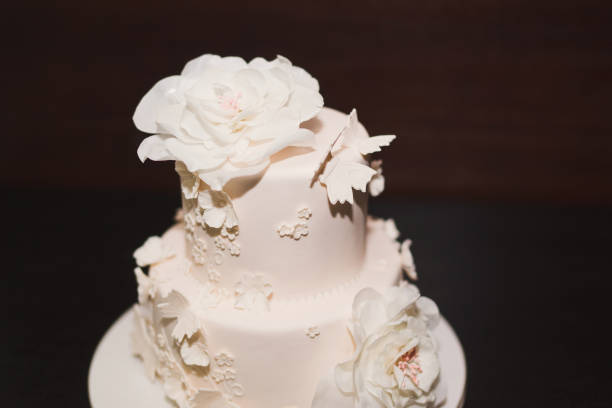 istock White wedding cake decorated with flowers and butterflies. 1395733752