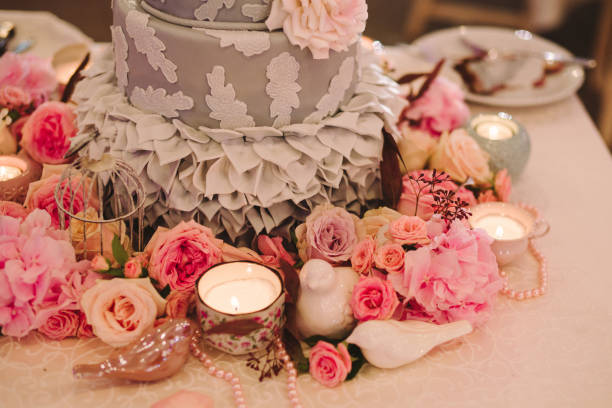 istock Gray wedding cake on decorated table with candles and flowers. 1395733770