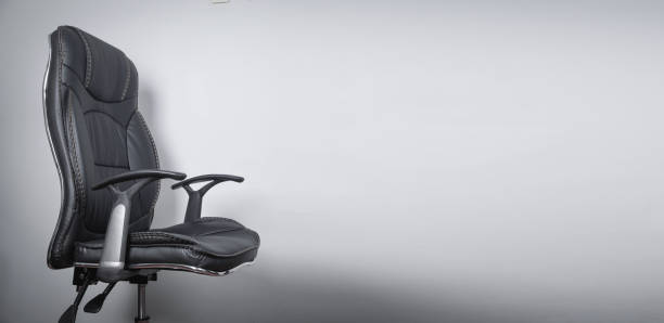istock Black leather office chair in grey background. 1395734437