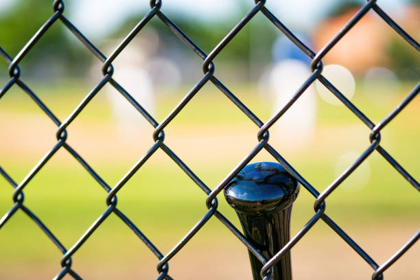 istock One baseball bat through fence 1395736261