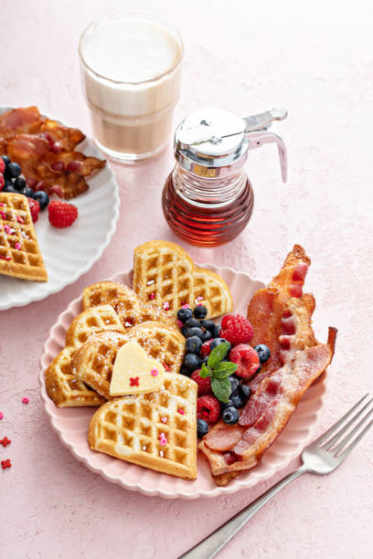istock Valentines day breakfast with heart shaped waffles, bacon and berries 1395736478