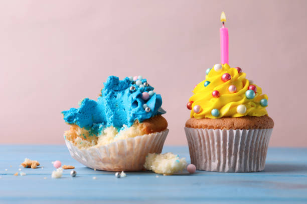 istock Failed and good cupcakes on blue wooden table. Troubles happen 1395741075