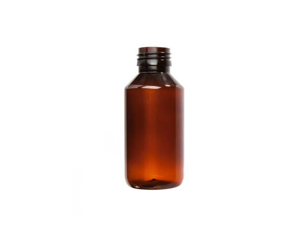 istock Small brown plastic or glass bottle. Small empty plastic or glass transparent bottle. 1395741956