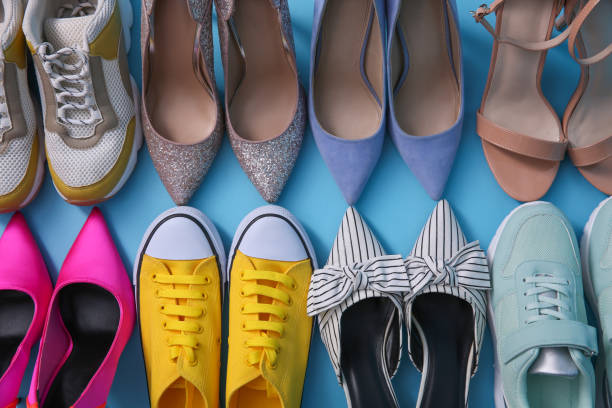 istock Different shoes on turquoise background, flat lay. Diversity concept 1395742804