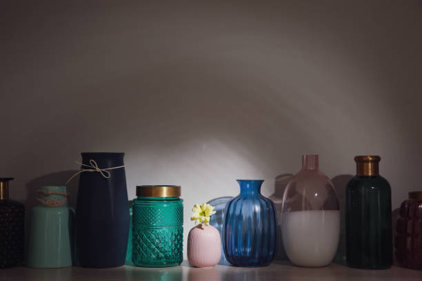 istock Vase with flower among empty ones on wooden table. Diversity concept 1395742813