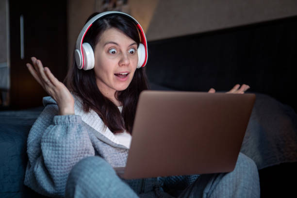 istock woman in headset working on laptop has video call 1395743339