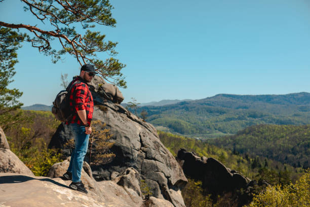 istock man hiker with backpack at dovbush rocks 1395743901
