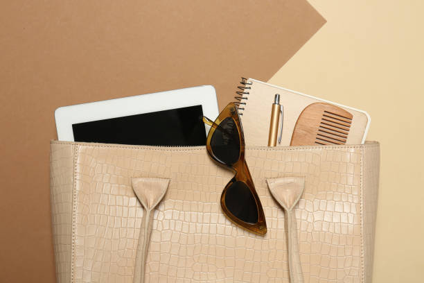 istock Stylish women's bag with tablet and stuff on color background, closeup 1395745694