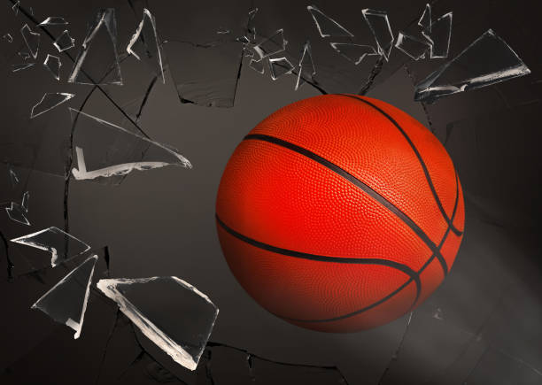 istock Basketball ball breaking up glass against grey background 1395745728