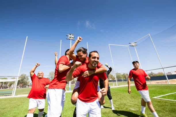 istock Soccer team celebrating victory 1395746681