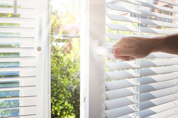Opening a modern window with blinds stock photo