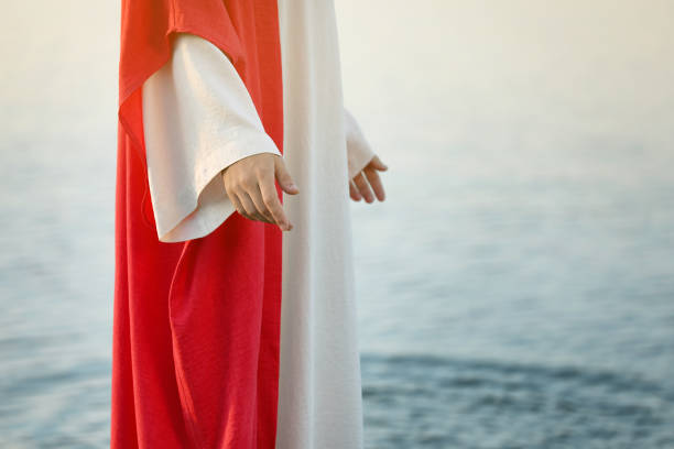 istock Jesus Christ near water outdoors, closeup. Space for text 1395748012