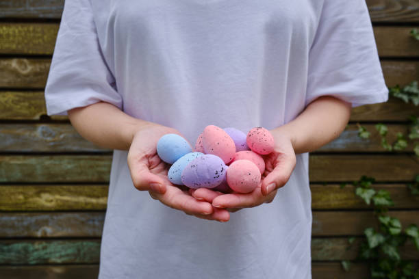istock Quail colored eggs in the hands. Easter banner. Eggs close-up. Easter mood 1395748177